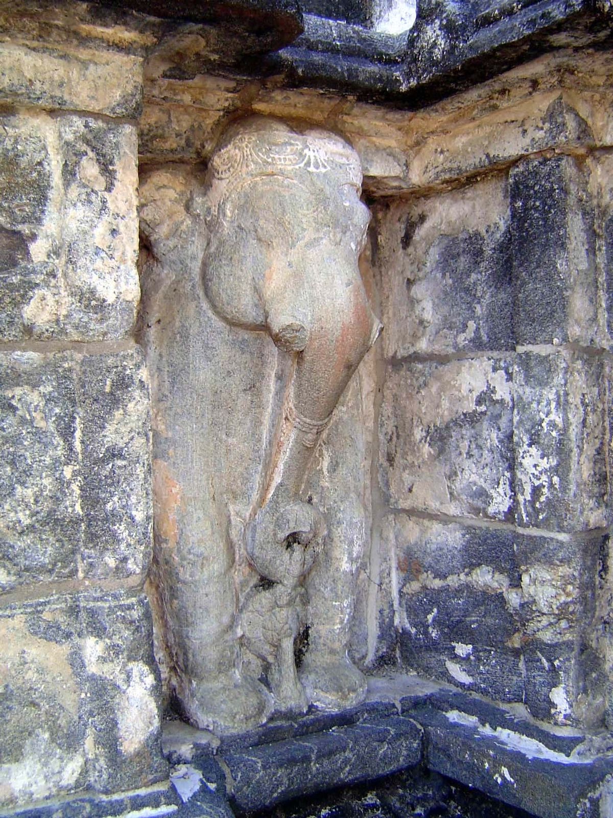 At the rear of the stupa platform, an emergent elephant.