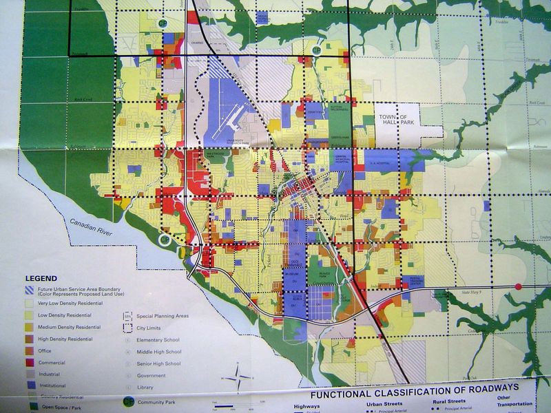 The city's land-use plan of 1997. Red is commercial, dominated by land along the freeway and section-road corners; downtown has shrunk to ne