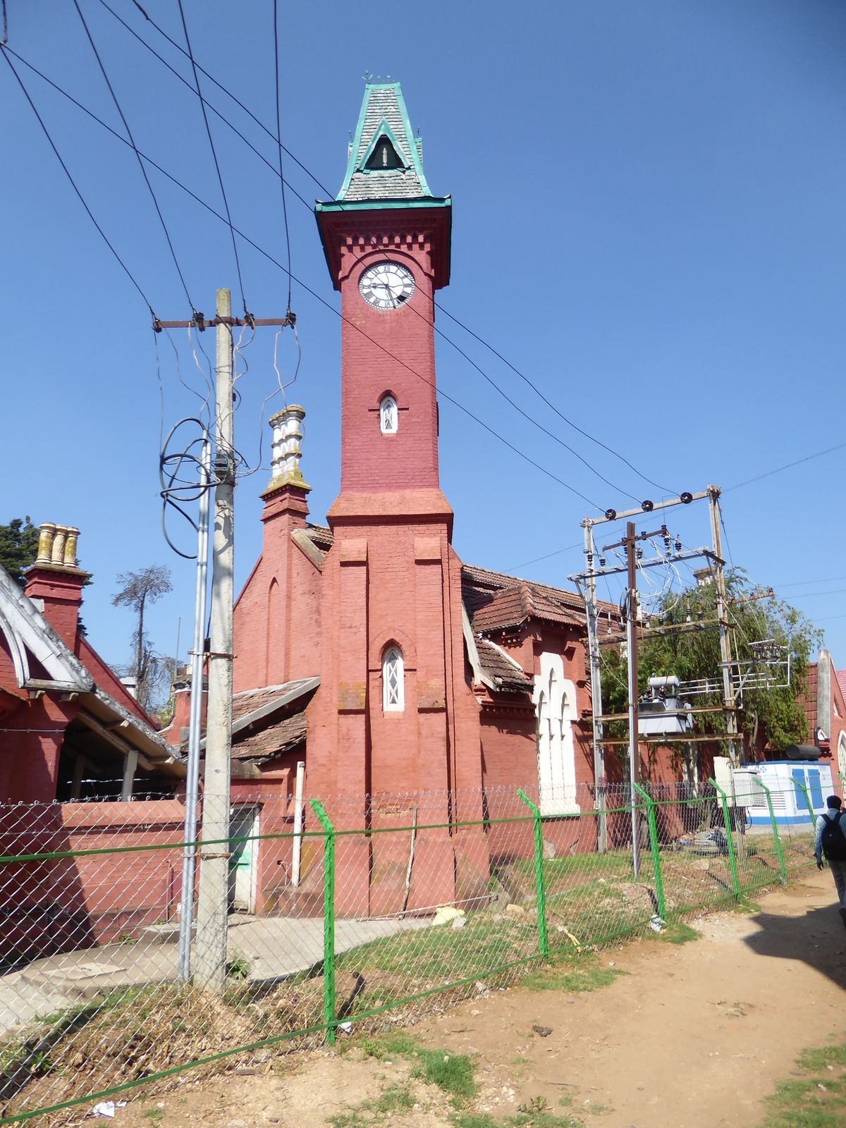 Ooty became the headquarters of the Nilgiris District, too. Here's the district courthouse. Wires and fencing pester the spindly clocktower.