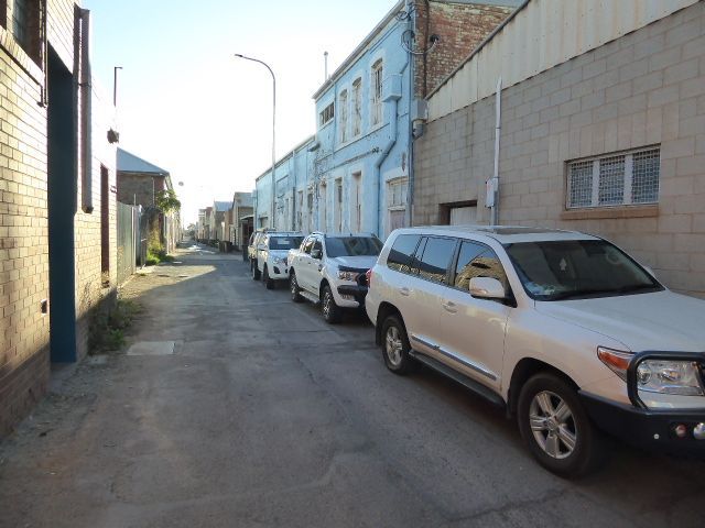 Out back, there's an alley, Argent Lane. The downtown blocks have such alleys; the residential parts of town generally don't.