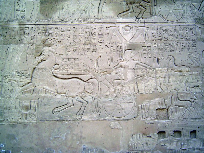On the same wall, Sety I, conqueror of the Hittites, smiles for posterity while driving prisoners back to Thebes as a gift to Amun-Ra. An in