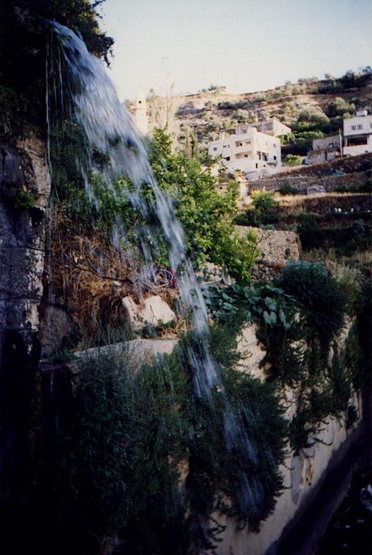 Water cascades from the chute to the pond. Even though agriculture has declined in the village, the spring and irrigation system are still t