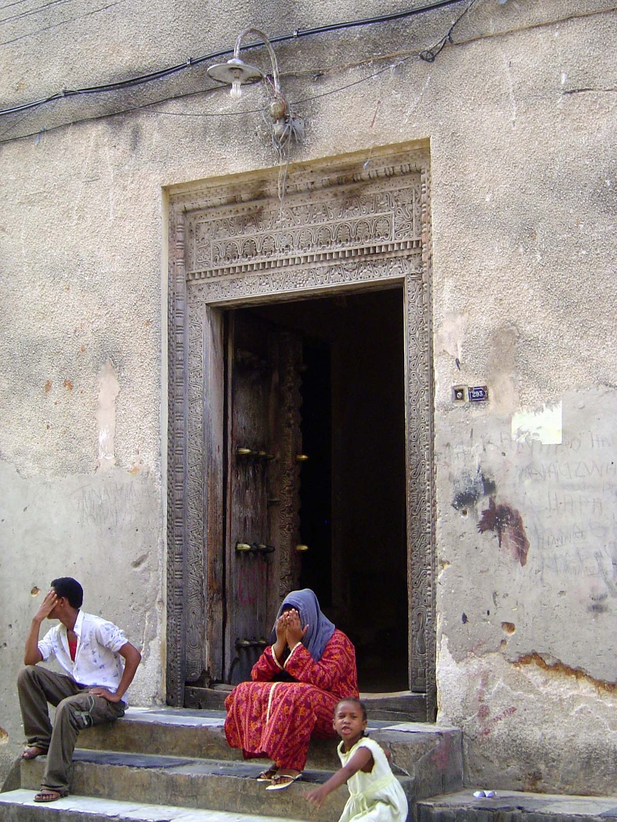 Tradition hasn't been entirely washed away by the tourist tide. Here, a fine Omani door with residents tired of cameras.