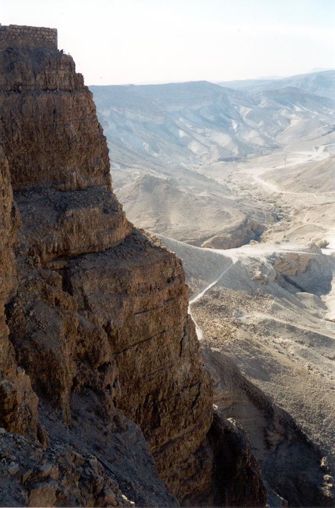 The cliffs look impregnable, but the Romans had time, labor, and experience. You can see here the residue of the earth ramp they built so th