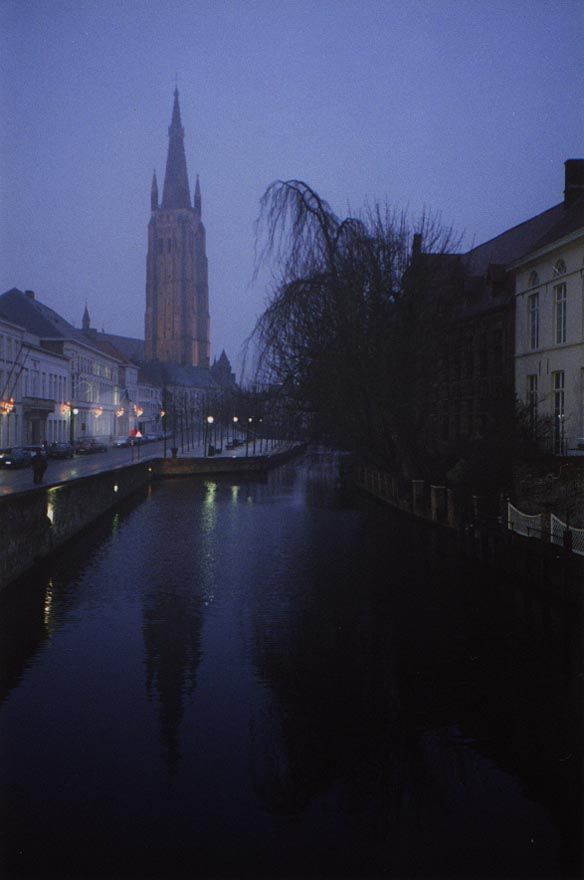 Bruges was wealthy enough to have some monumental buildings, too. Here's one, the Church of Our Lady, mirrored in Steenhouwers Dijk.