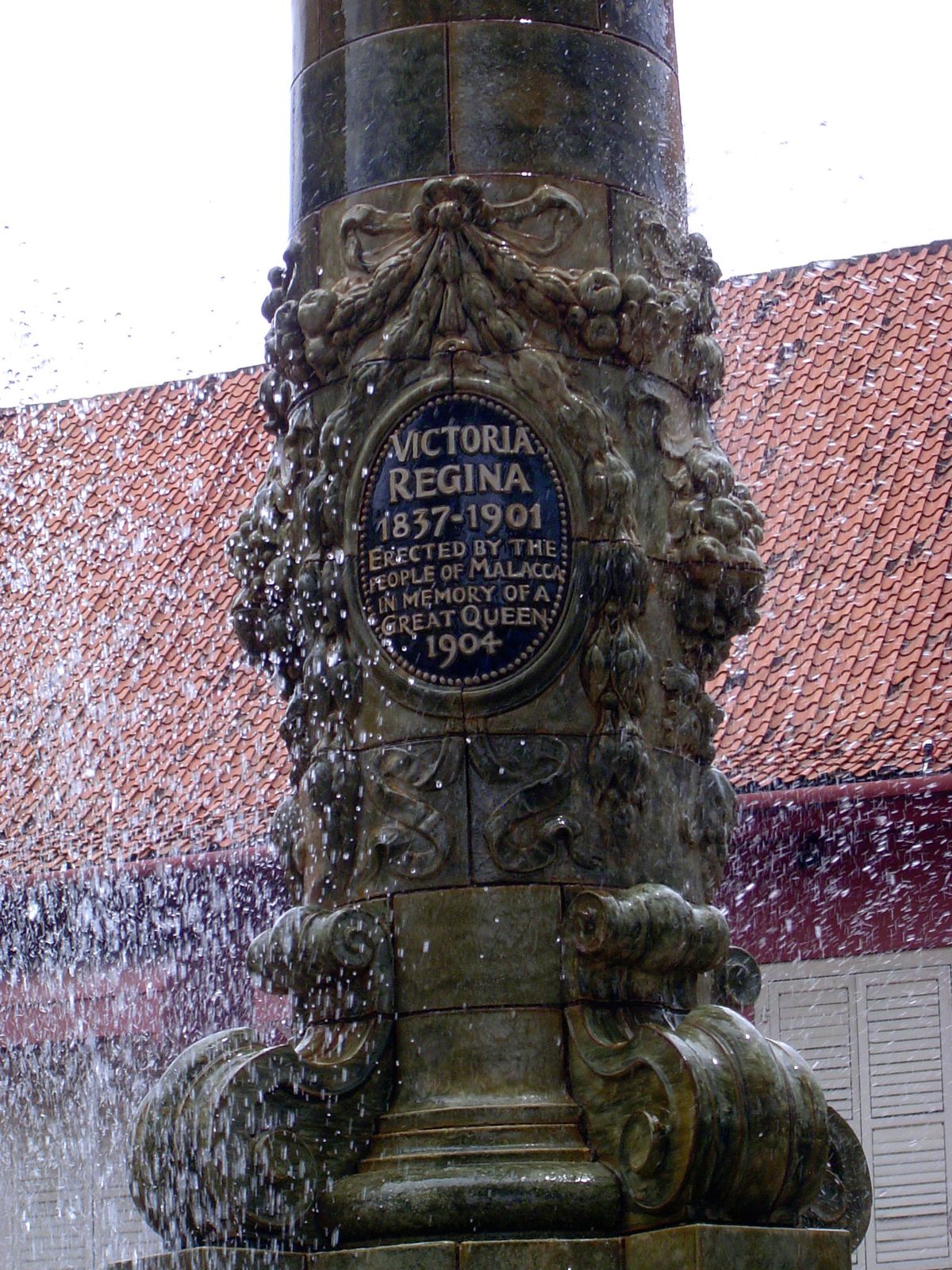 A Victorian fountain, missing from the postcard, has been added and still plays.