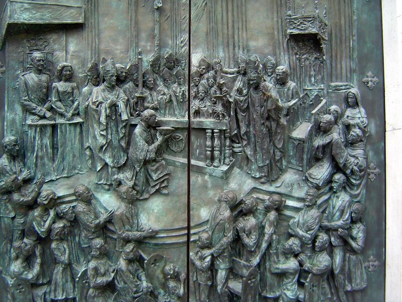 Bronze doors show figures of the time.