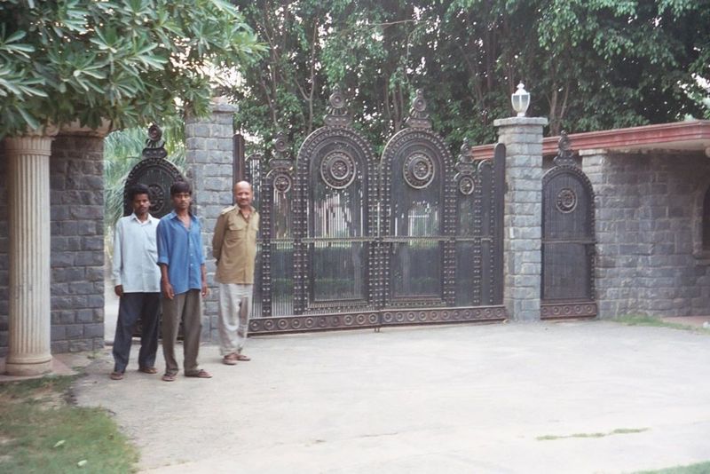 Far out on the city's southern fringe, the wealthy have built hundreds of walled estates known, misleadingly, as "farms." Here, the gate to 