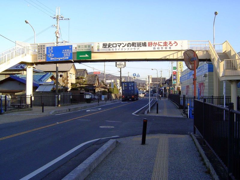 A dozen miles away, on the walk to Horyuji, an overhead sign asks motorists to drive carefully in Ikaruga, which it calls a romantic and his