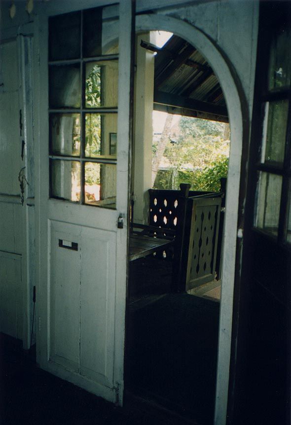 The rectangular doors are replacements for the original ones, which curved to fit the doorway. Why replaced? Because the house was used by t