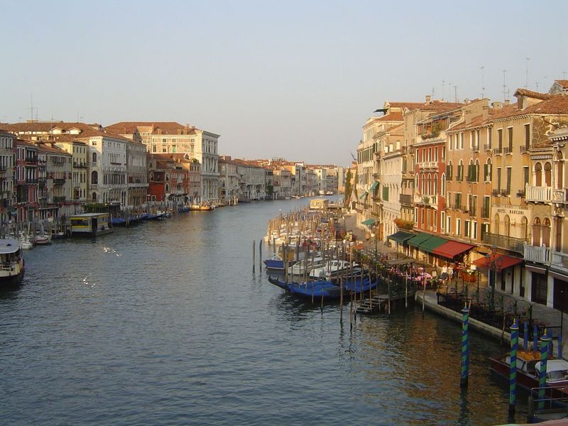 From either side of the bridge, the canal gently curves away. This view looks south. On the left, after a succession of smaller buildings a 