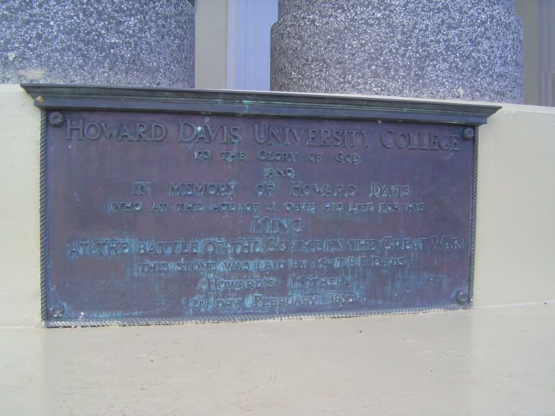 A plaque explains the name of the college.