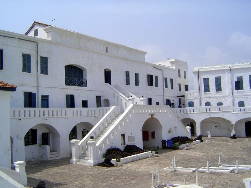 Inside, a fine courtyard, surrounded on three sides by massive buildings.