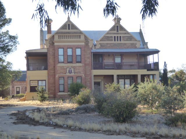 The fanciest house in town is the bishop's house of 1913, now private. In 1926 a new home for the bishop went up nothing but the best for ou