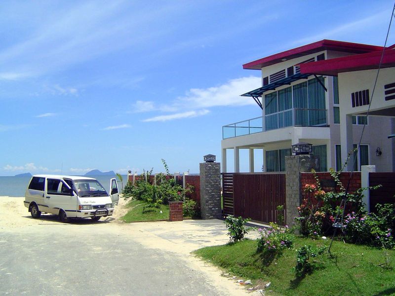 A mile down the road, the sandy beachfront belongs to someone with money.
