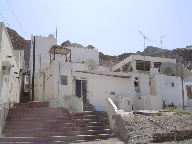 Houses are nothing fancy but are fitted with antennas, dishes, and air conditioners.