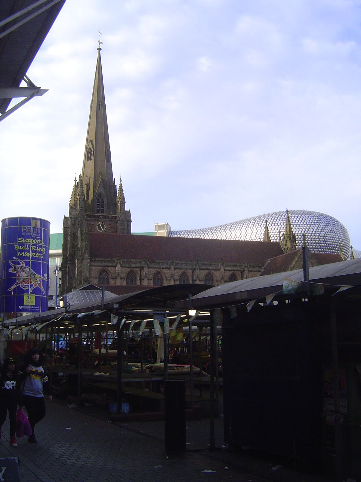 What grabs your eye? Not the open-air market, plunged in shadow. Not the city's old church, St. Martin in the Bull Ring. Inevitably, it's "t