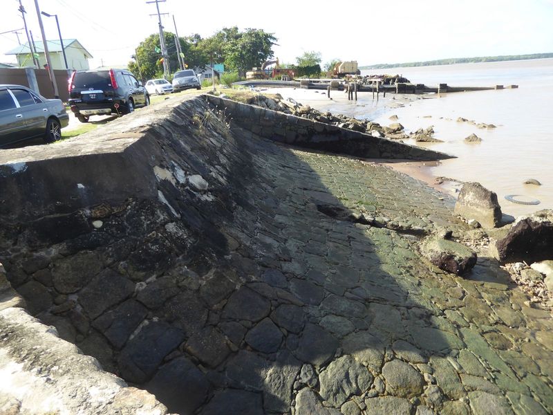Construction of the sea wall began in the 1850s with convict labor placing blocks of granite floated down from quarries on the Mazaruni, a t
