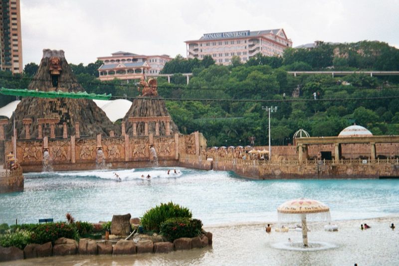 The pool has a wave-making machine. Up top, there's a Malaysian branch campus of an Australian university.