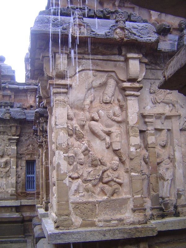 The walls of the vimana are elaborately sculpted with two dozen figures, two at each corner and four on the sides between. The figures are i