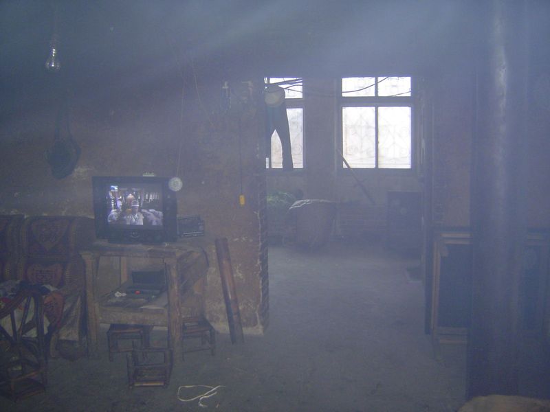 Inside, it's smoky. The black column on the right is concrete, not some exotic timber. The television brings both the mythical Chinese past 