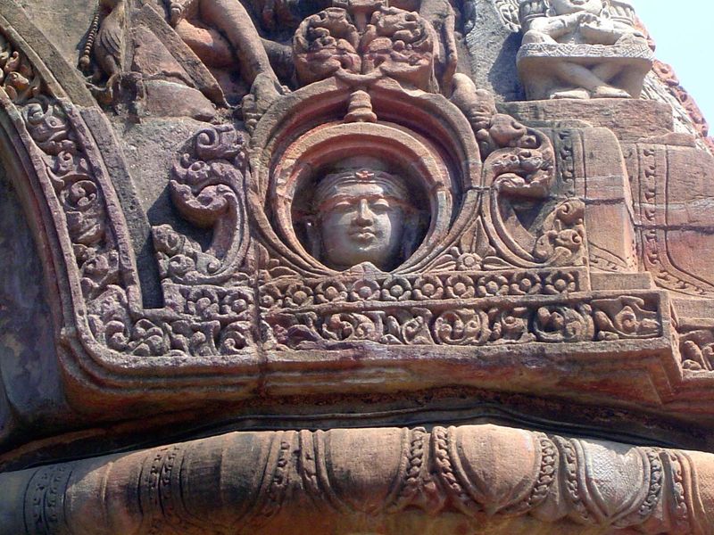Still closer: a figure in a window. The gods keep watch.