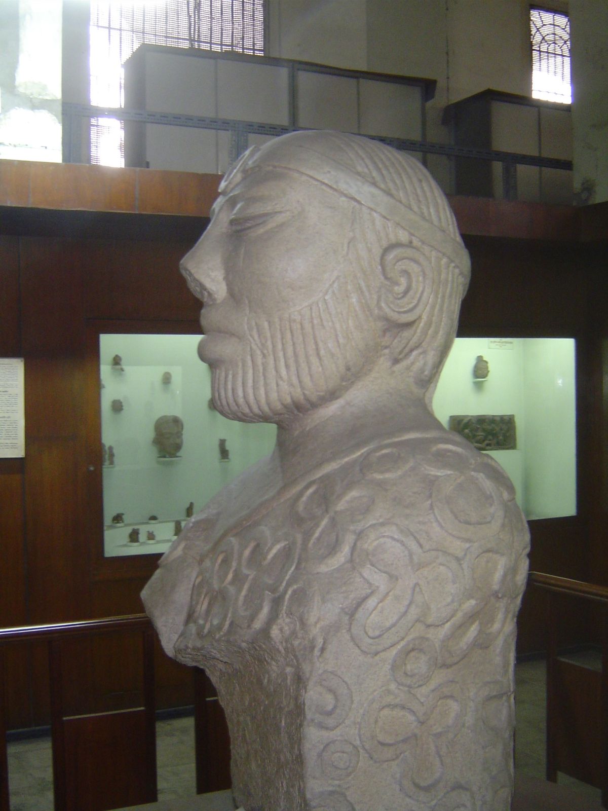 Another view of this oddly realistic yet stylized figure, aristocratic and withdrawn behind heavy eyelids.