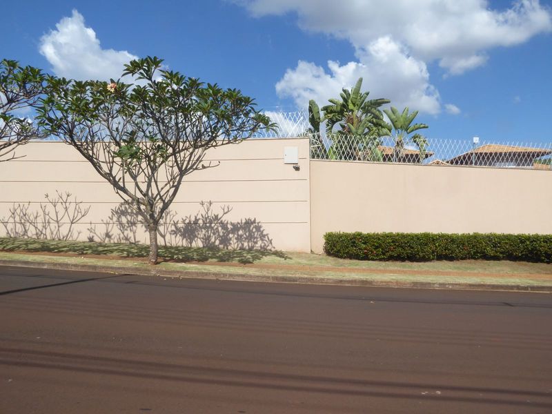 The wall is topped with razor fencing topped with electric wires.