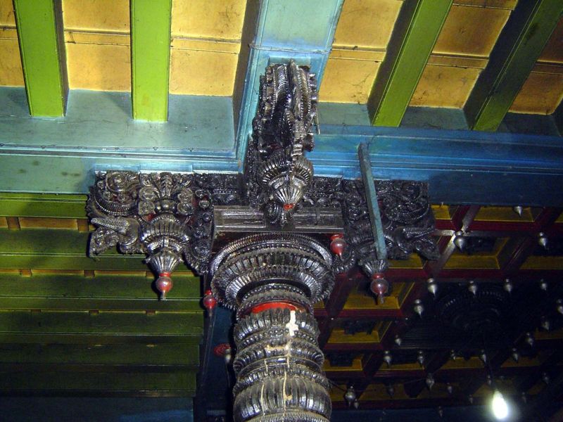 Before the inner sanctum, a quartet of elaborately carved columns.