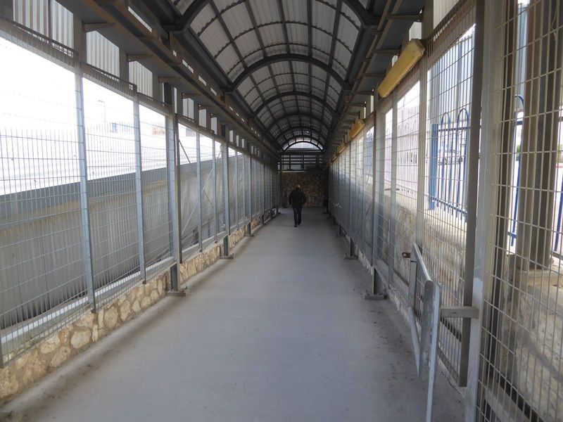 Pedestrians coming into Israel pass this way, with turnstiles ahead and document checks.