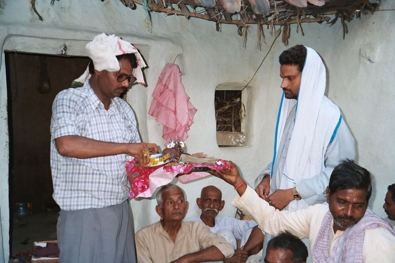 The big moment: a bundle of rupees is handed to the groom's representative.