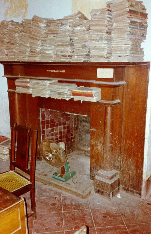 The interior consists of a few enormous rooms. Judging from the paperwork stacked on the mantelpiece, the fireplace in one of those rooms wa