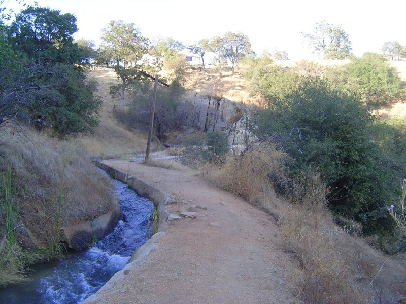 Does the country look a little dry for fruit trees? Well, that's where irrigation ditches came in handy, like this one, which burbles over t