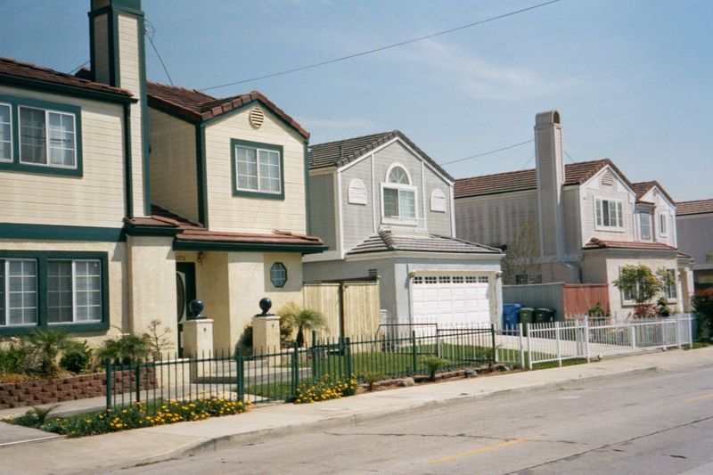 Watts has new houses, too, like these on Santa Ana Boulevard. They're proof that the community isn't completely sidelined. The minimal fenci