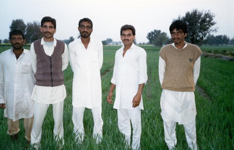 Agribusinessmen of Khaluwas, posing next to the irrigated land that is their wealth.