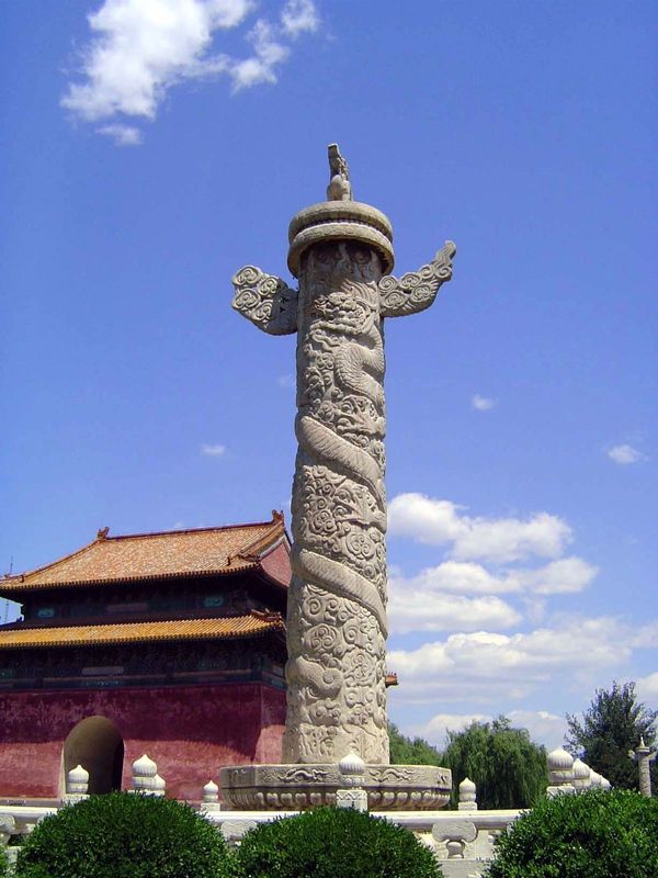 Four dragon-wrapped, cloud-piercing columns frame the pavilion. Identical ones at Tiananmen are called huabiao, or "monumental columns." The