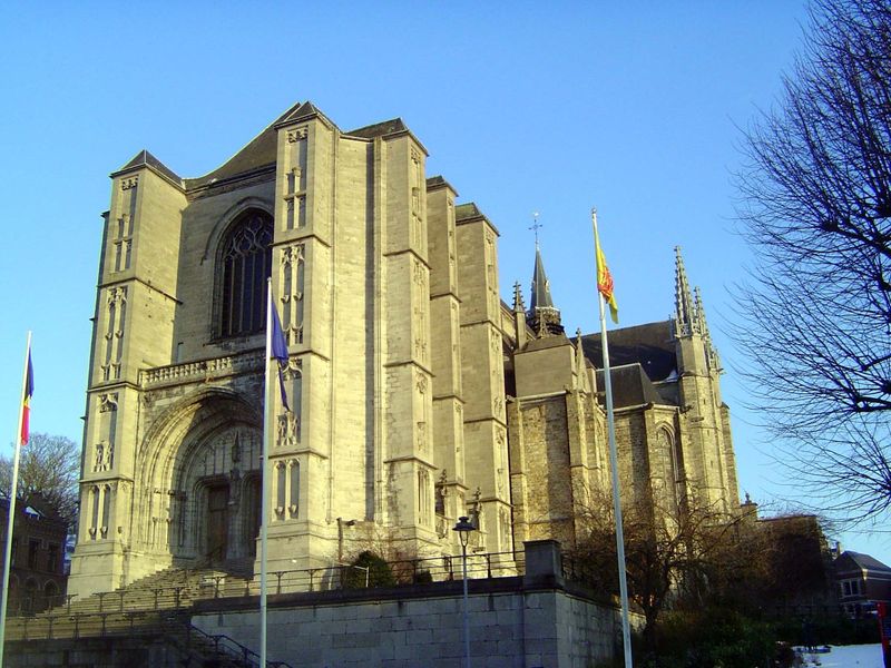 It's the eerily modern Church of Sainte-Waudru, finished in 1506. Towers were planned but never built.