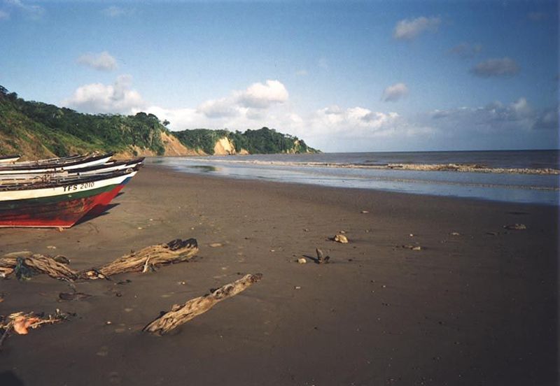 The same beach, deserted except for a few fishermen.