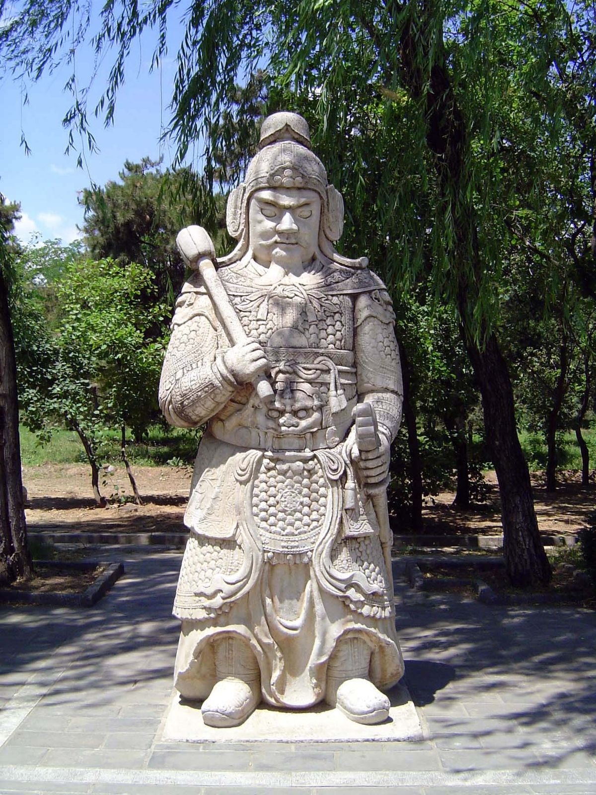 Pairs of sculptures line the sacred way. Here, a military figure.