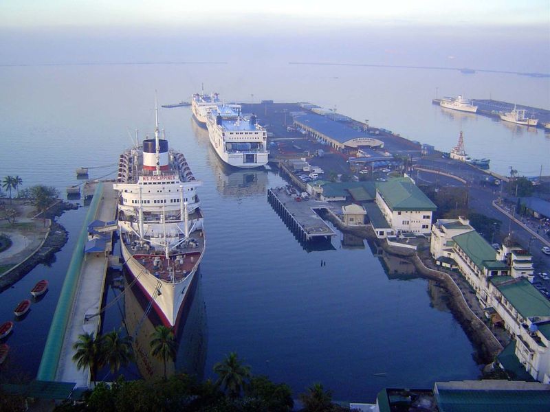 Piers 13 and 15, seen from the Manila Hotel. The liner tied up at the left is the M.S. Philippines, which hasn't moved for years. The ship w