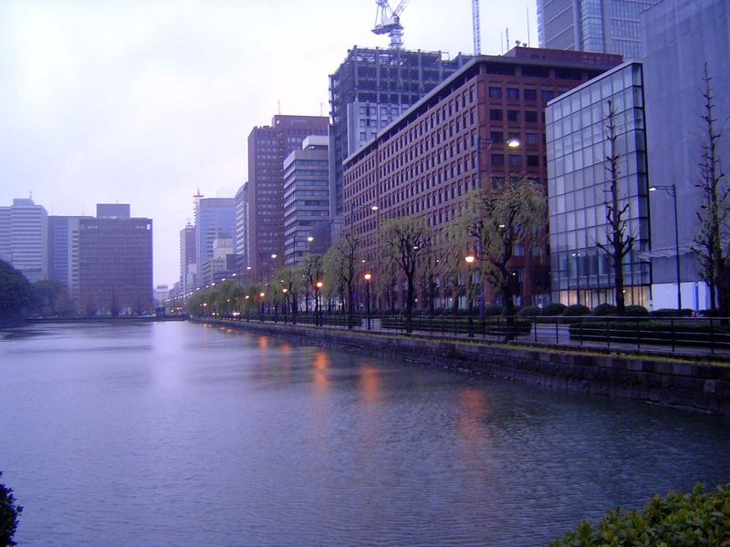 Off to the left, the Imperial Palace is hidden behind its moat and forest. On the right, Marunouchi, literally "within the walls," a name th