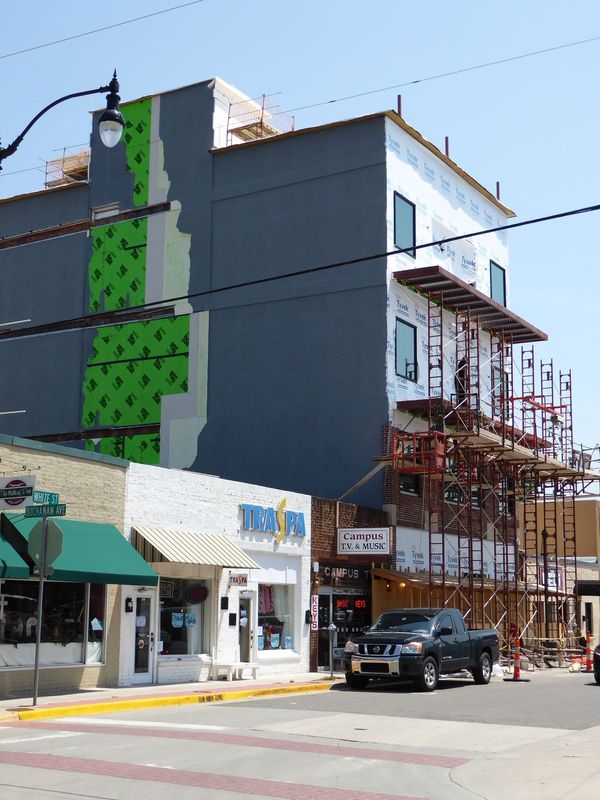 Across the street, the world's only four-story pizza place was under construction in 2015. Easy to overlook, Campus TV opened in 1960; its o
