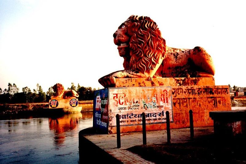 Some miles downstream, the canal waters pass these old lions, guarding a famous aqueduct.