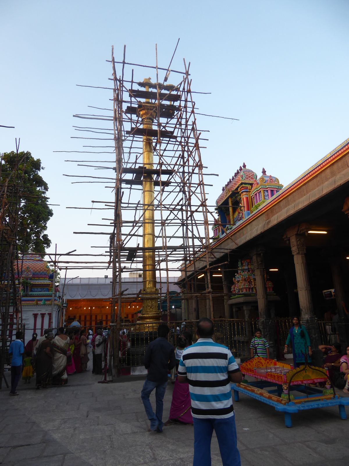 A brass lamp-column stands outside the main Shiva shrine.

Originally located on the coast, the temple was destroyed in 1566 by the Portugue