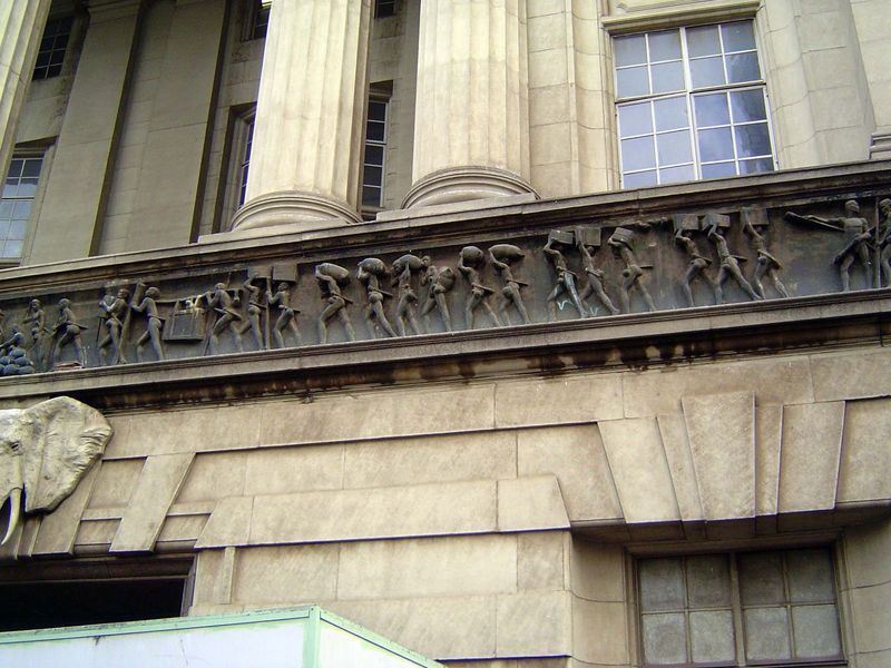 The frieze shows the evolution of land transport, starting with porters.