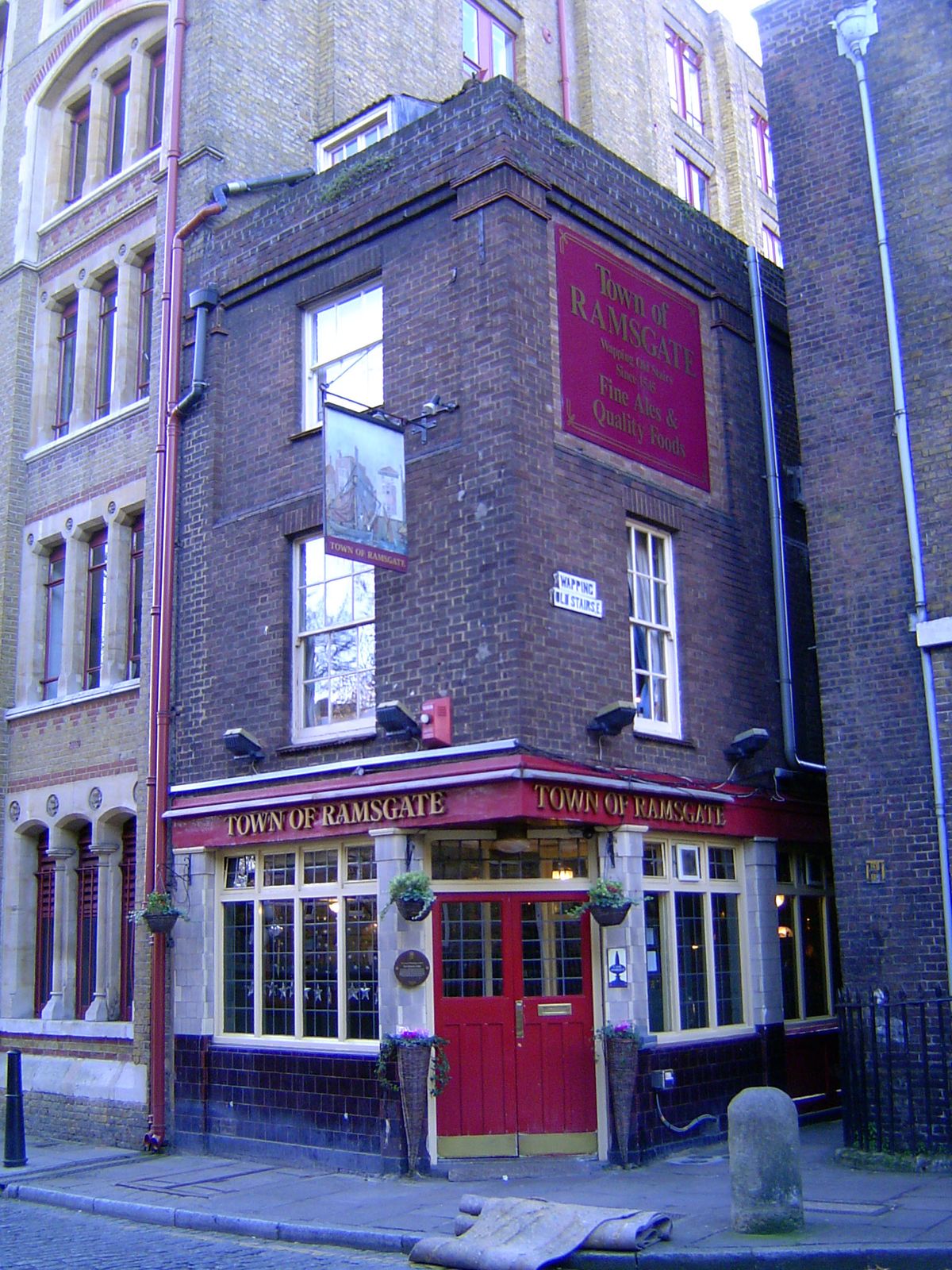 Another alley leads to the river. The black and white street sign reads Wapping Old Street.