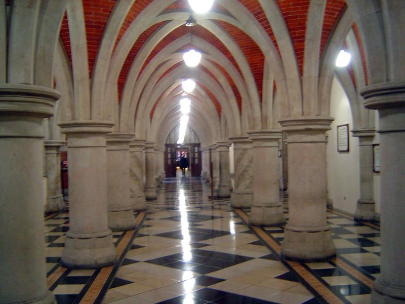 A corridor leading to one of the building's many courtrooms. Nairn chortles about "stuffy Dickensian rooms where lawyers argue endlessly thr