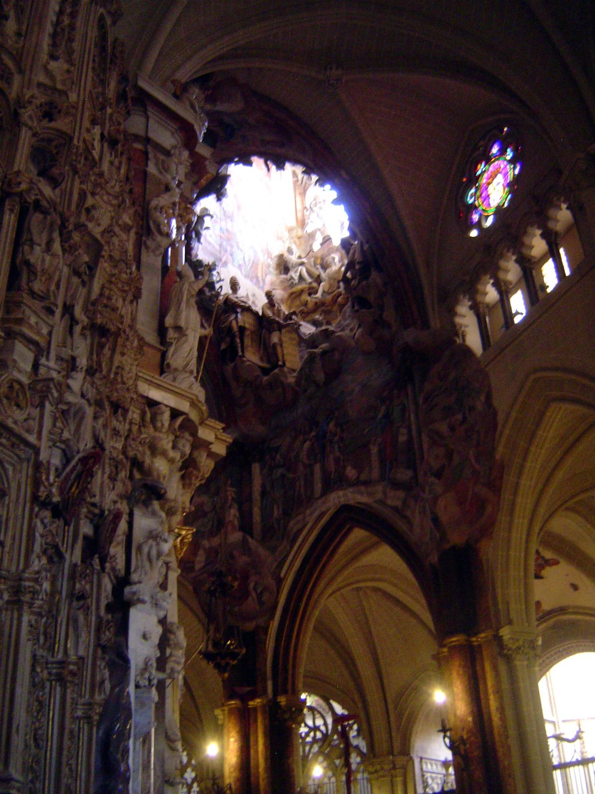 High above, a window has been opened and walled with flamboyant ornament. Ford dismisses it as a "fricasee of marble" and "much depraved inv