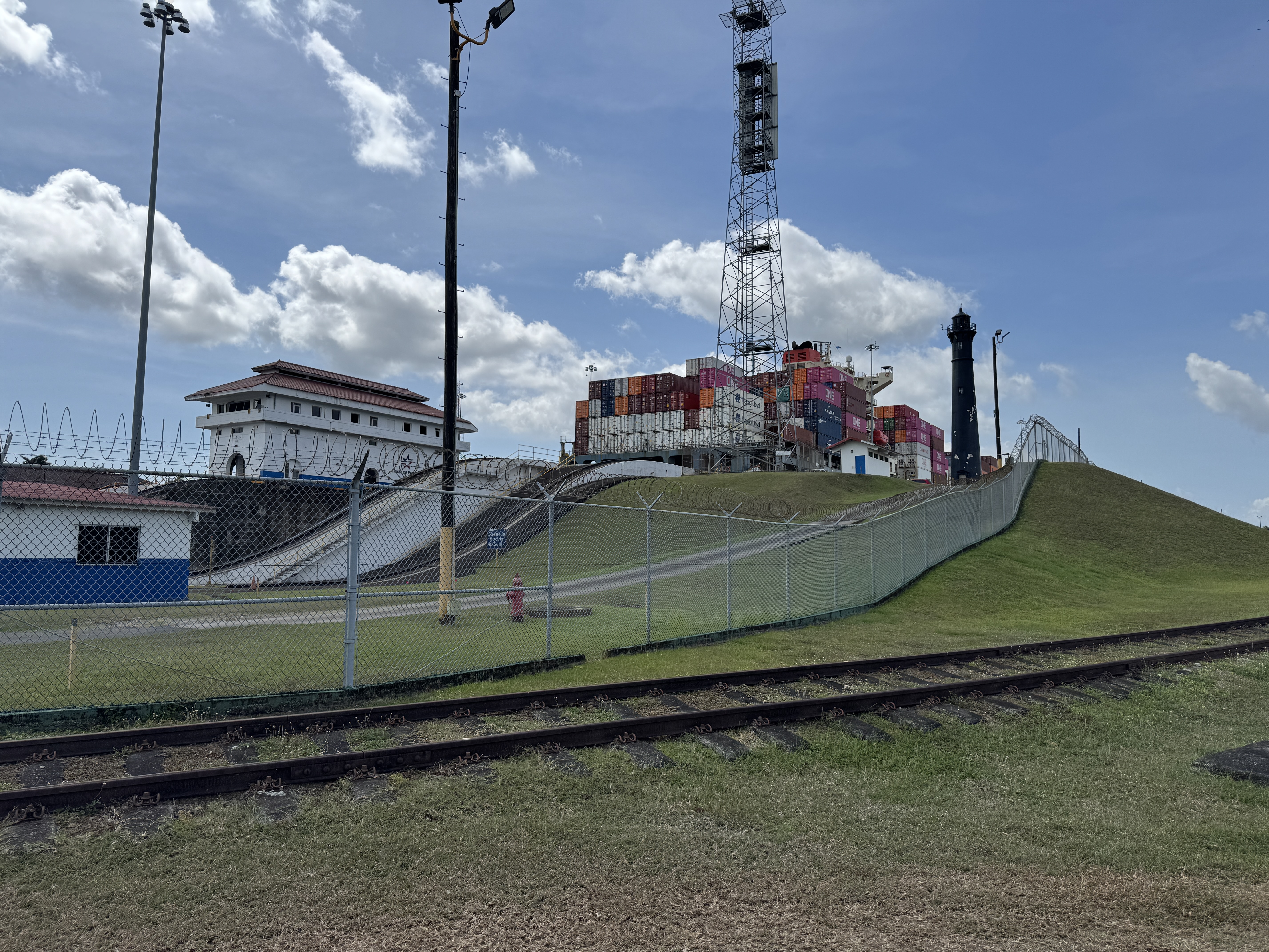 It's hard to see the old locks, but the containers here aren't on land.  They're on the Japanese-owned, Panamanian-flagged Mol Experience.  