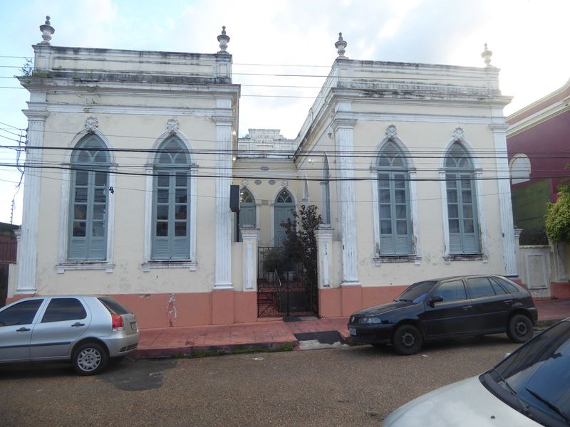 Here's a public school from 1895; it's close to the same Igarapé Educandos. When the local student population declined with slum clearance, 